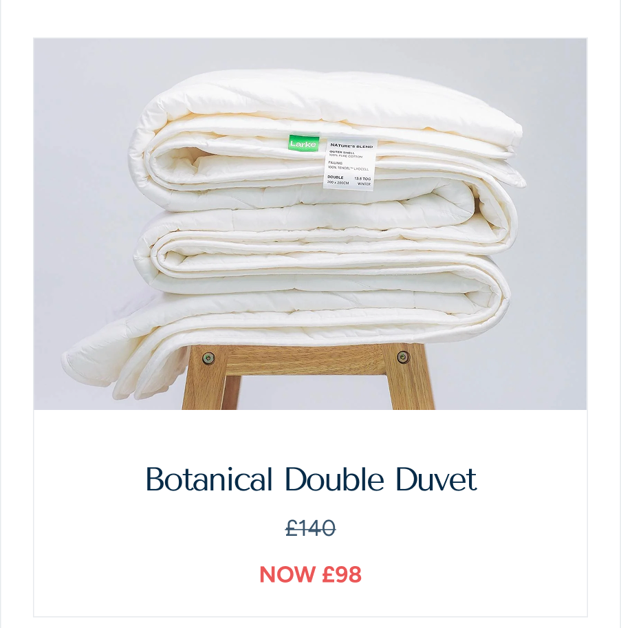 An image of a folded "Botanical Double Duvet" on a wooden bench, with the label: "Botanical Double Duvet, showing the reduced price after discount"