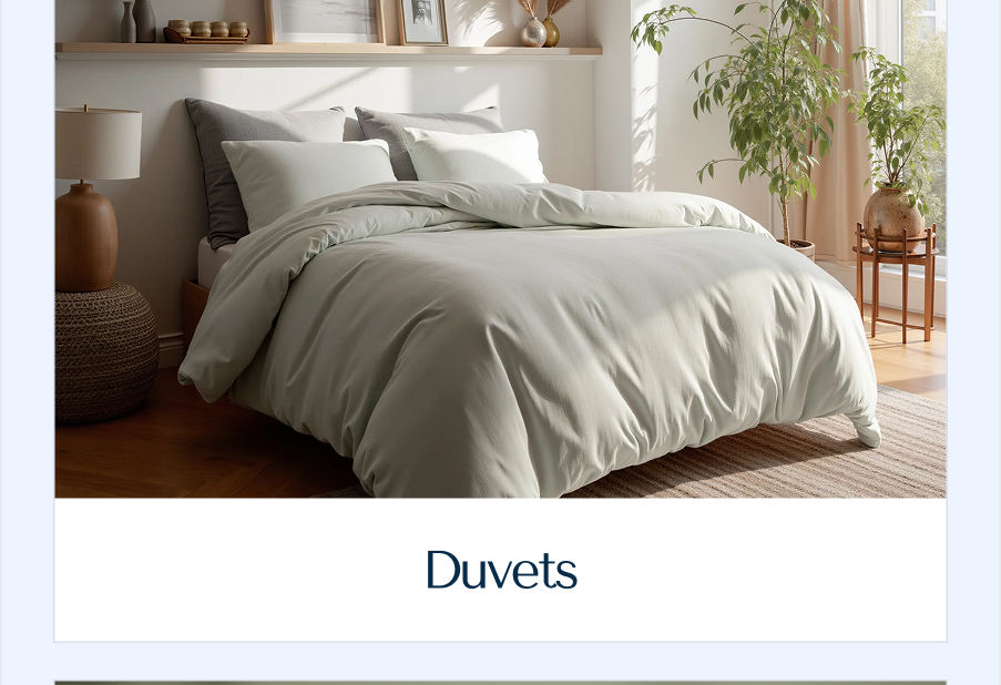 An inviting, sun-drenched bed layered with a thick, voluminous pale mint-green duvet cover.